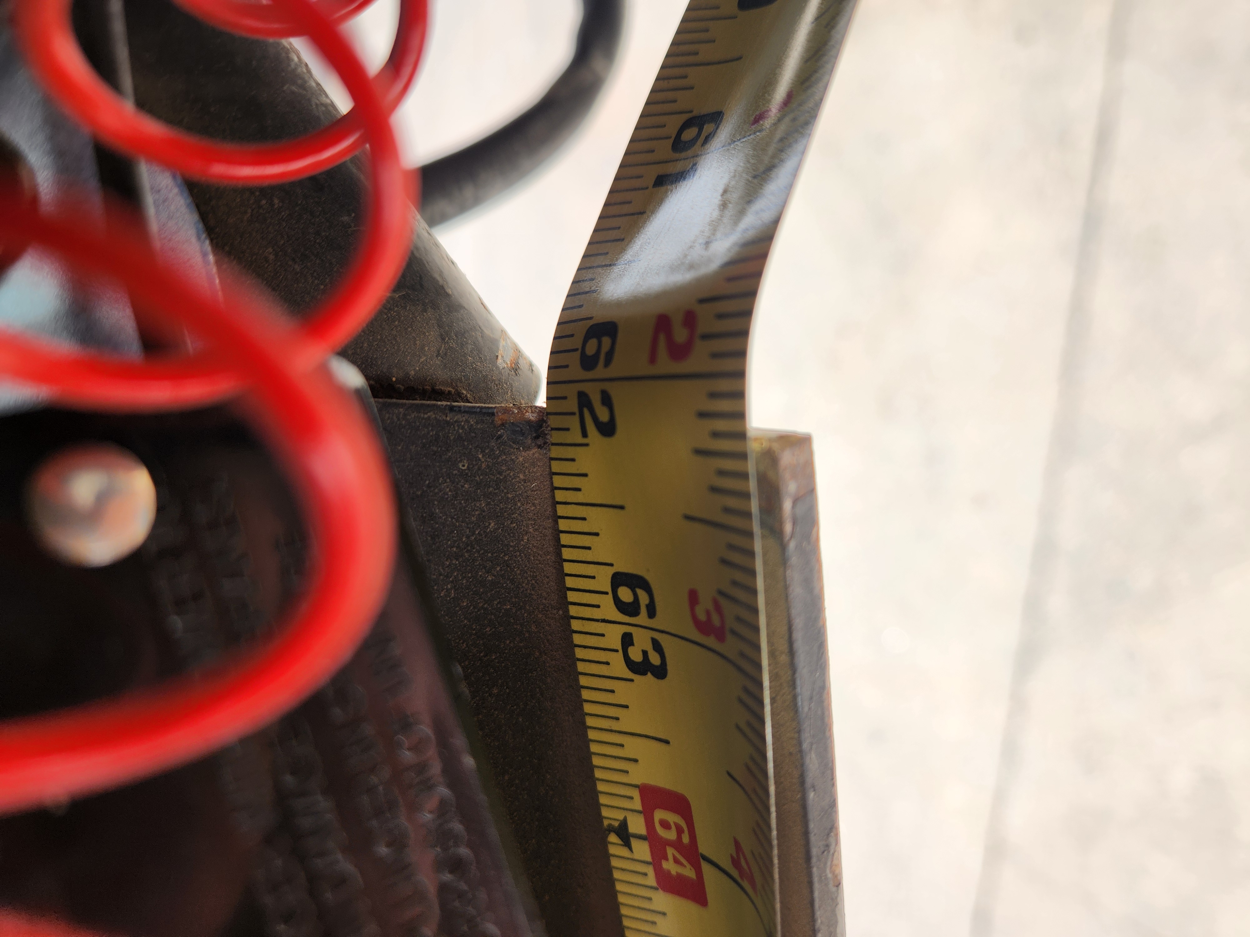 Frame flex measurement on the ground showing 62 and 1/8 inches from pin-box to frame