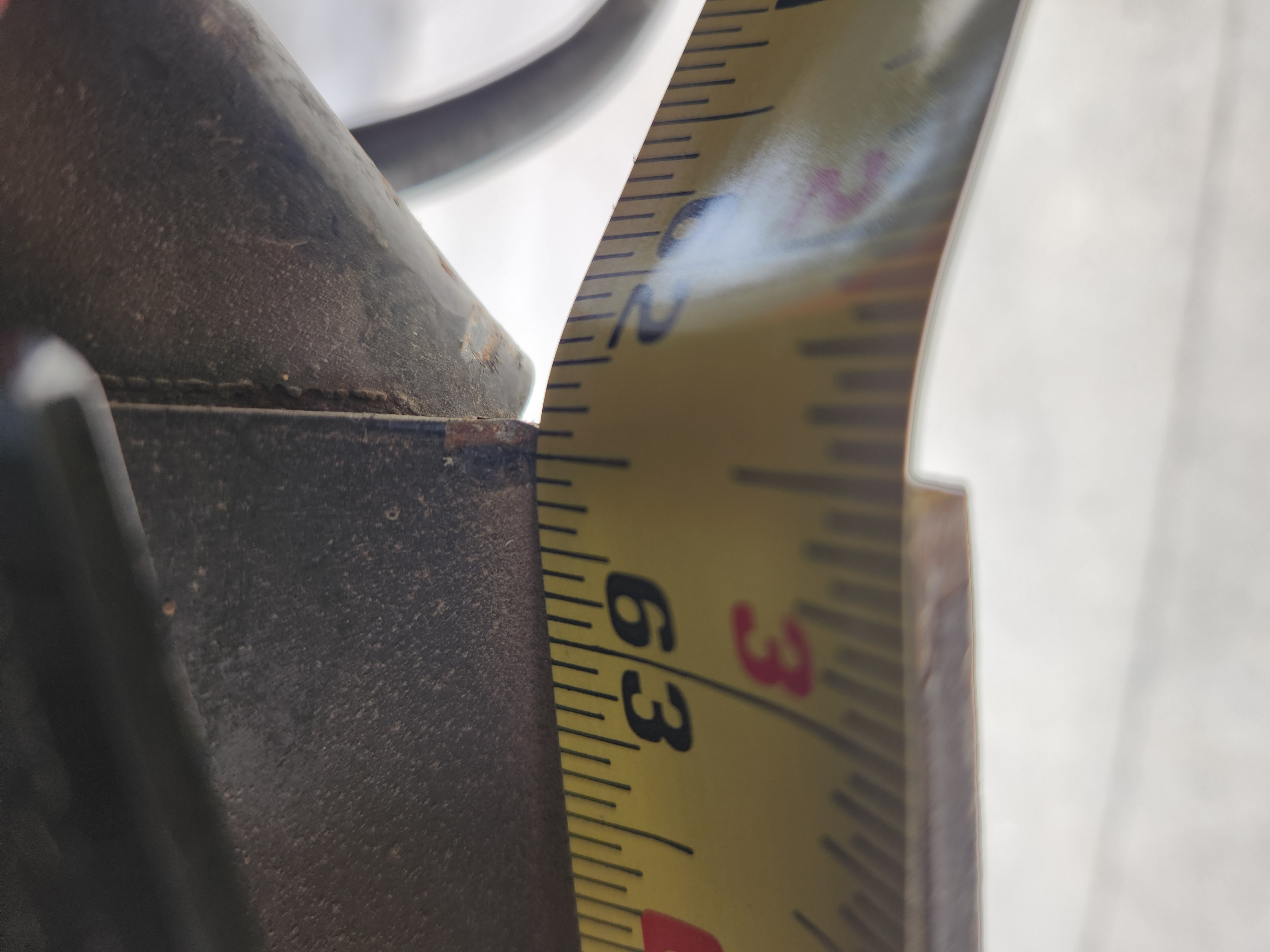 Frame flex measurement while lifted showing 62 and 7/16 inches