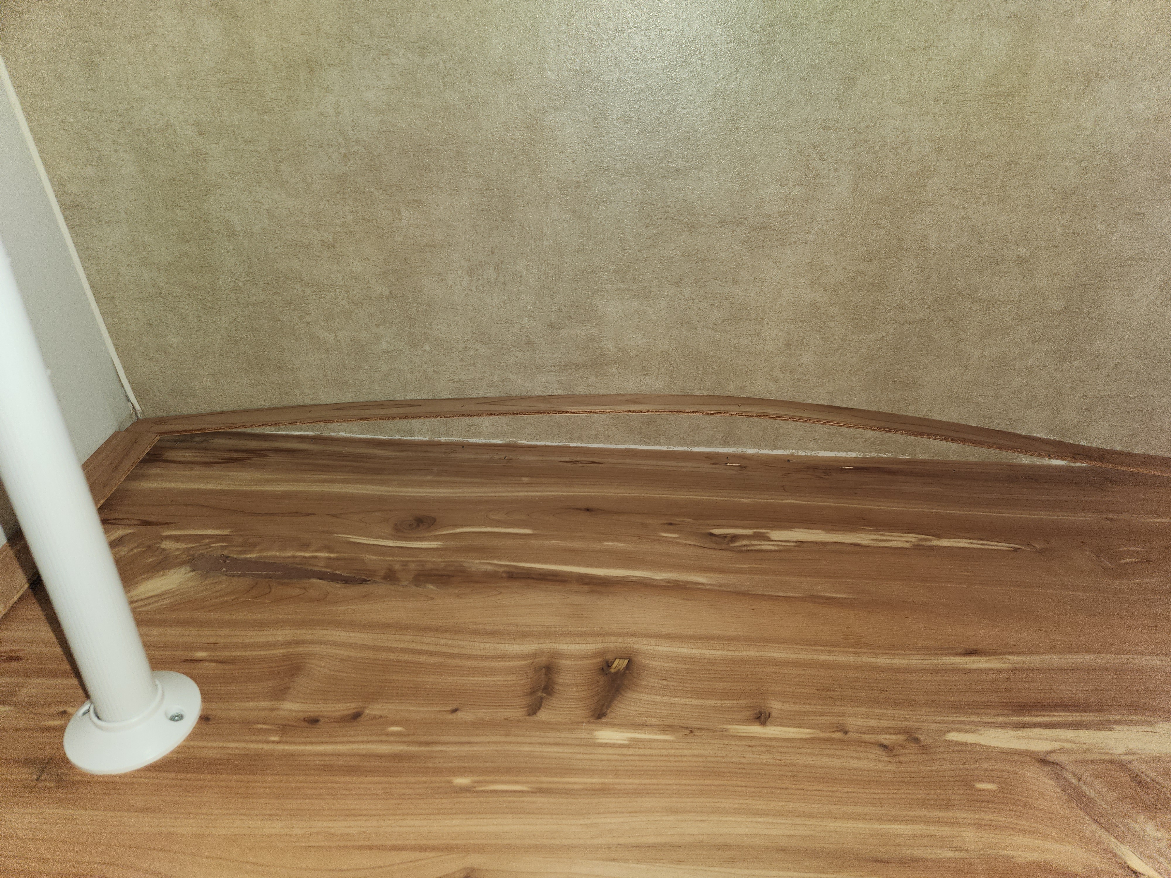 Obvious structural distress visible in bedroom closet with warped trim separating from wall