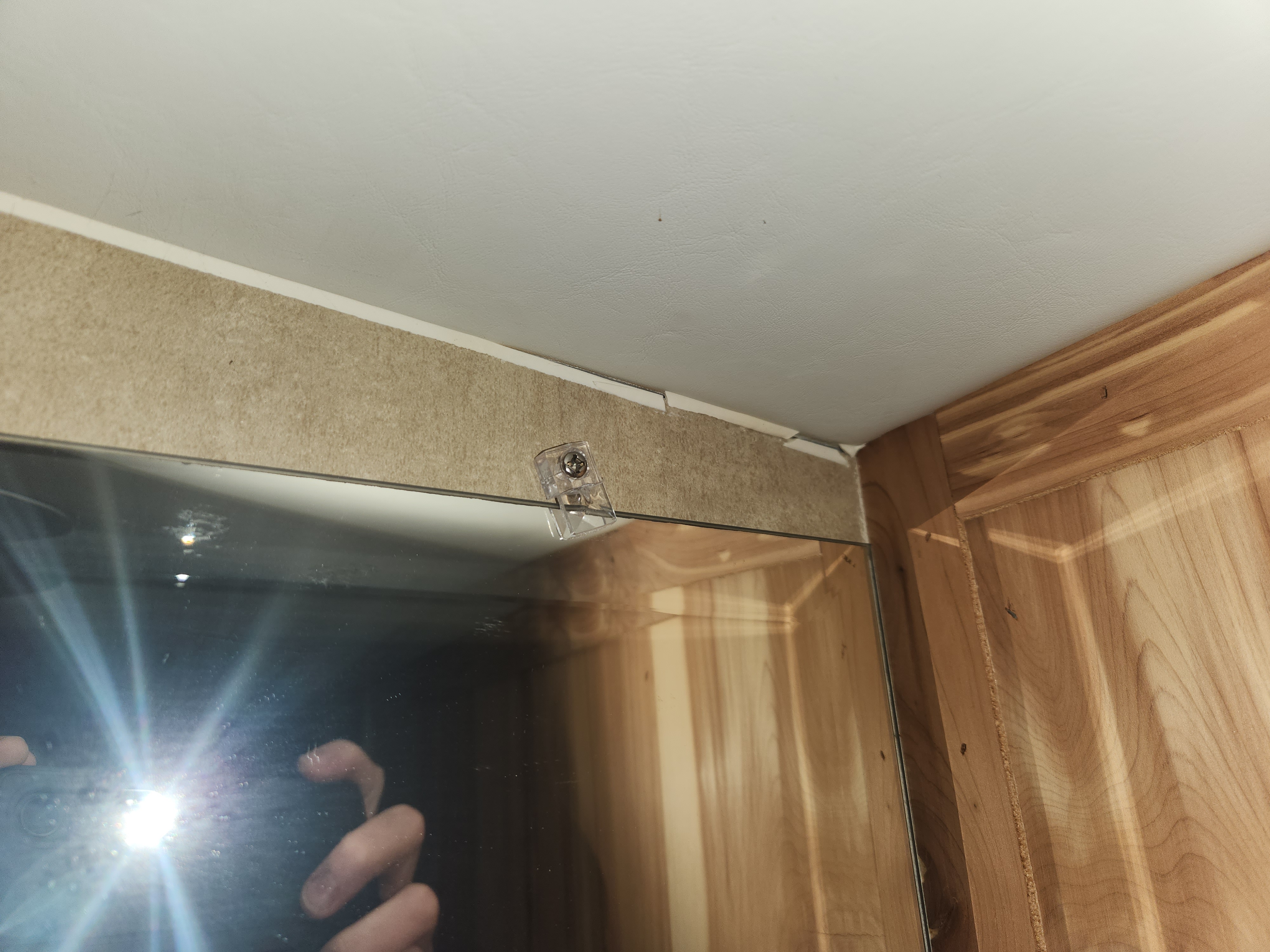 Opposite ceiling corner showing compressed gap while RV is raised